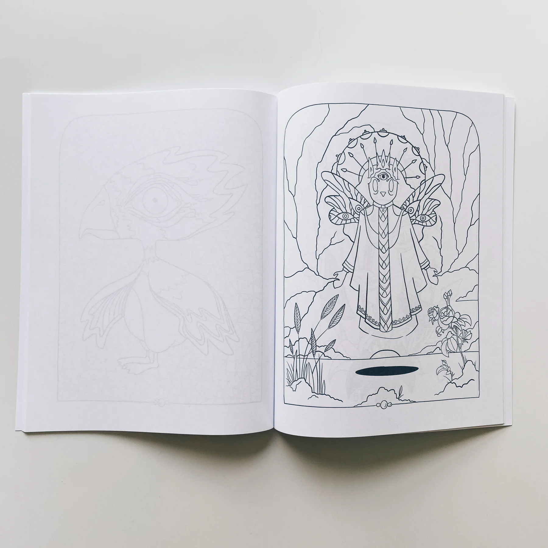 interior page of weird lizas colorama volume 1 showing cat priestess floating. page is uncolored, book open on white background.