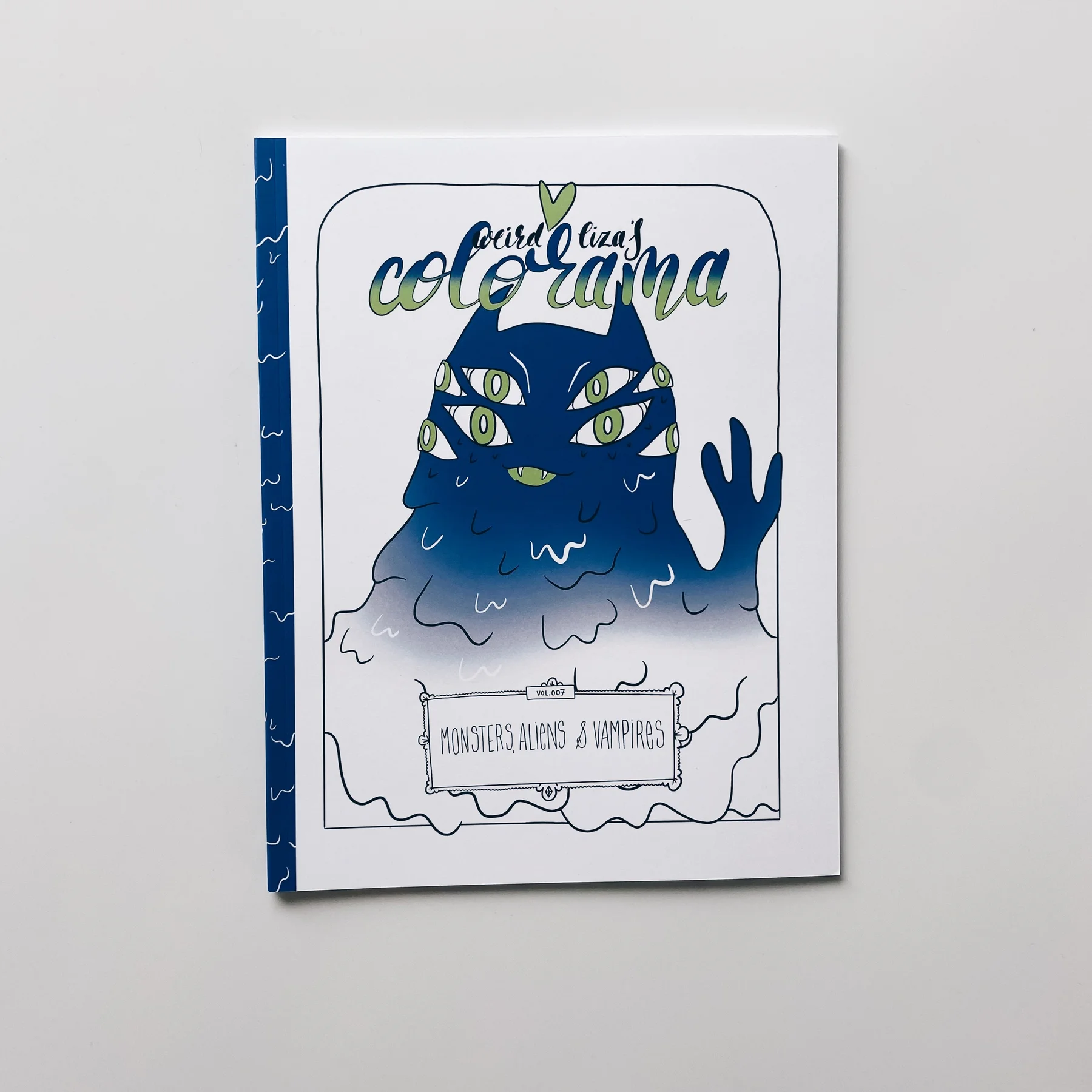coloring book cover of weird lizas colorama volume 7 with friendly alien vampire monster waving on white background.