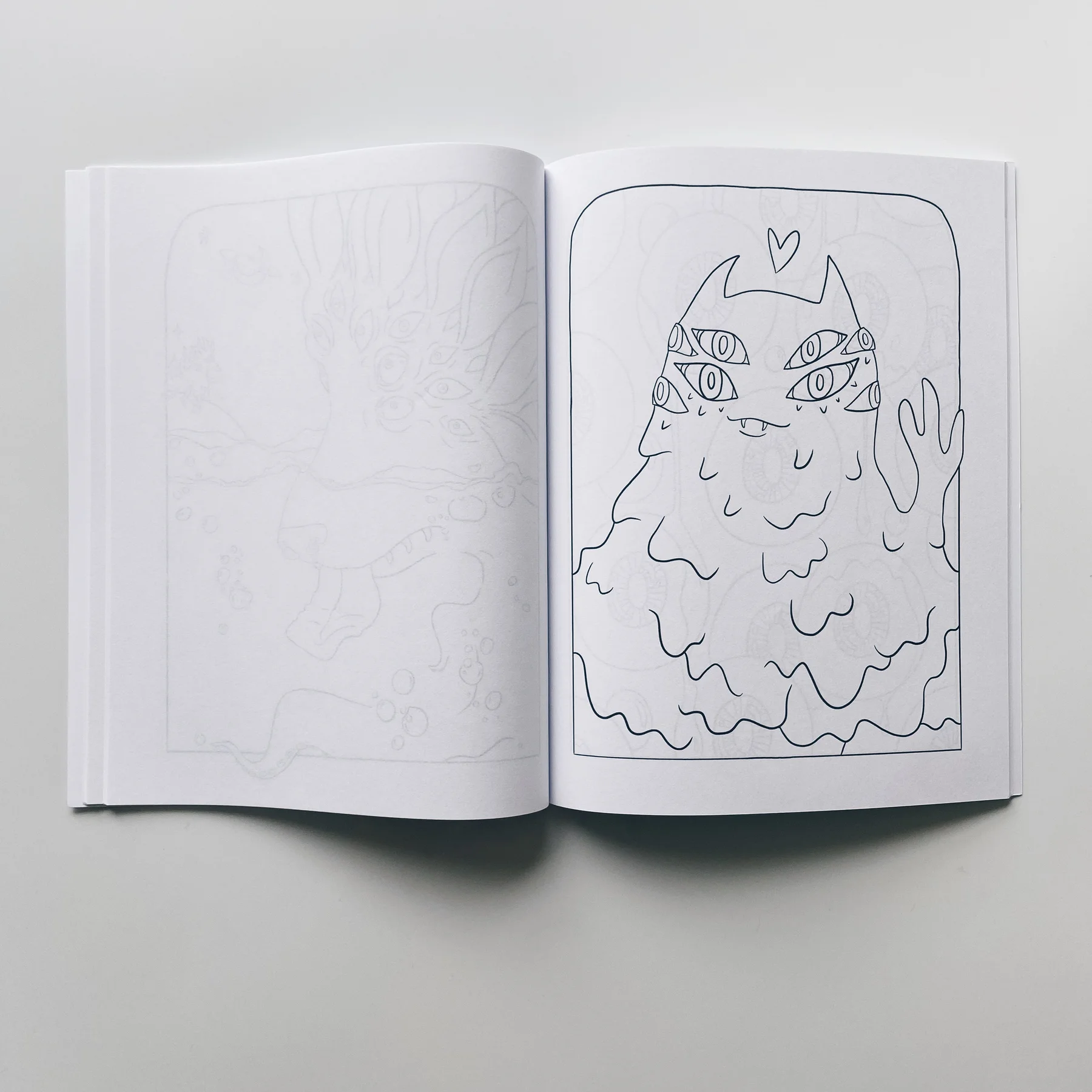 interior pages of weird lizas colorama volume 7 with friendly alien vampire monster waving. page is uncolored, book open on white background.