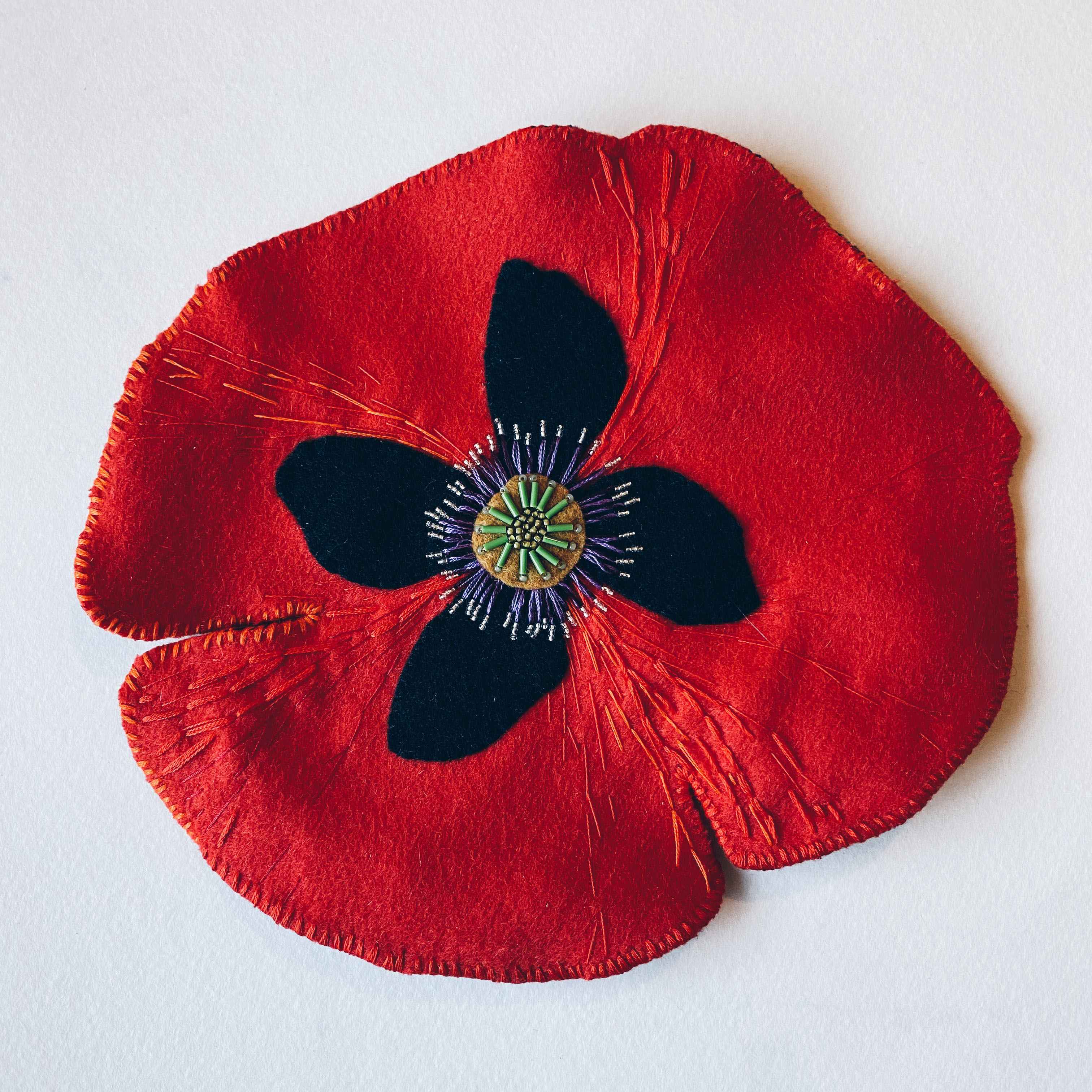 Large red hand embroidered and beaded poppy brooch.