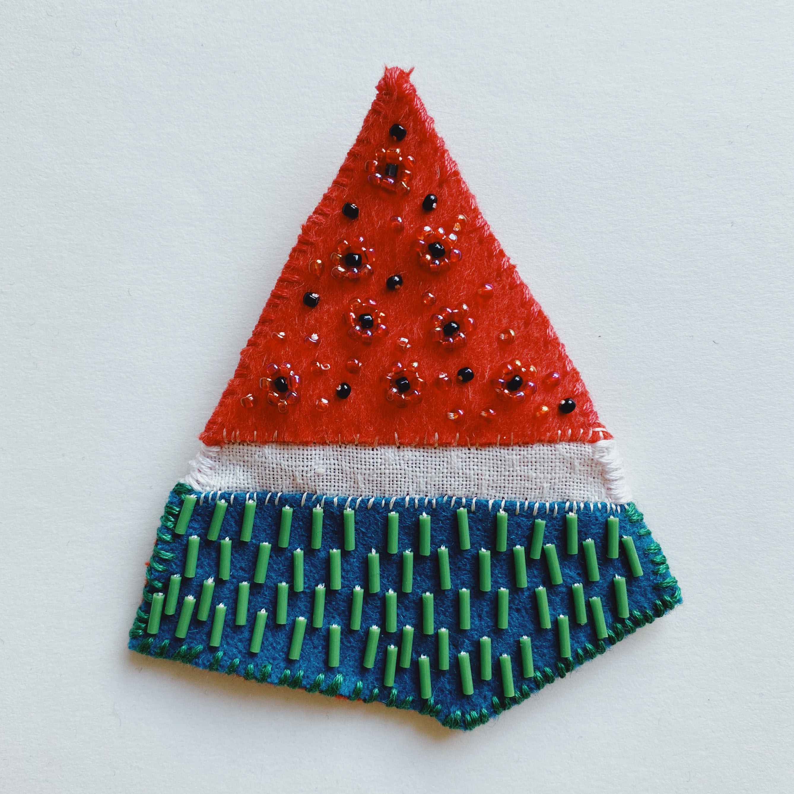 watermelon, wedge shaped, red green and white brooch with beading.